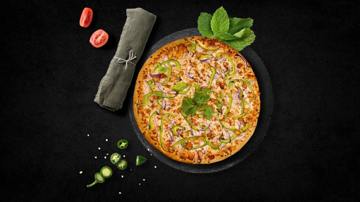 Noni's tandoori chicken pizza — chicken, green peppers, red onions and cilantro on a fresh-baked crust